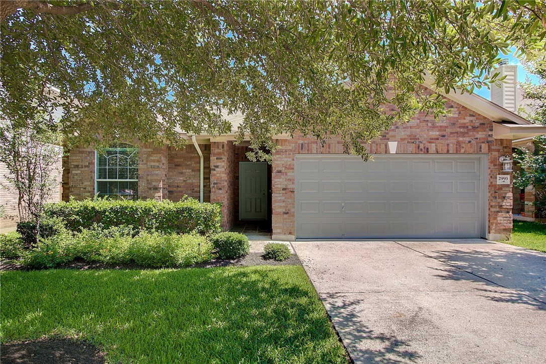 2993 Freemont Street Round Rock, TX 78681 - Photo 2 of 32 a front view of house with yard and trees around