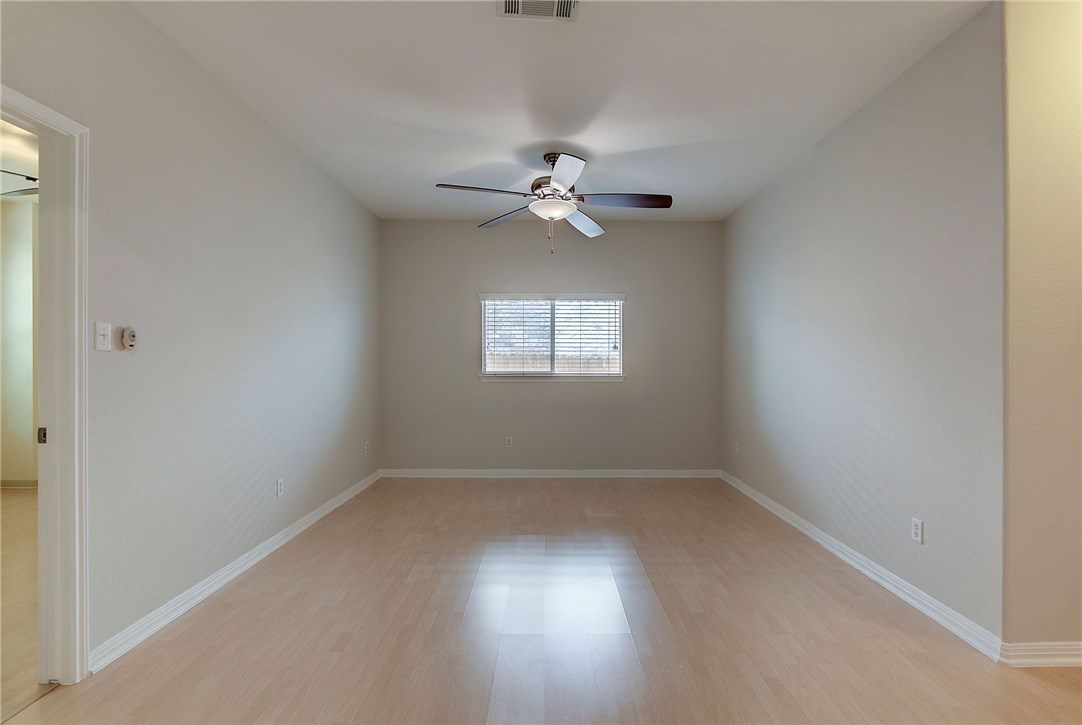 2993 Freemont Street Round Rock, TX 78681 - Photo 22 of 32 wooden floor in an empty room with a window