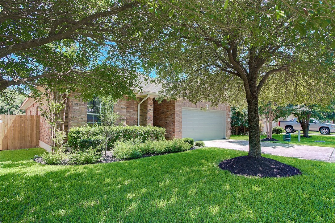 2993 Freemont Street Round Rock, TX 78681 - Photo 3 of 32 a front view of a house with garden and tree