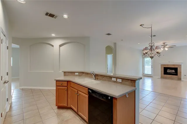 a kitchen with a sink a counter space and cabinets