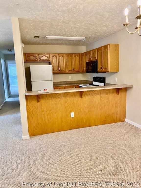 1945 Sardonyx Road, Unit 4 Fayetteville, NC 28303 - Photo 3 of 17 a view of kitchen with stainless steel appliances granite countertop refrigerator sink and stove