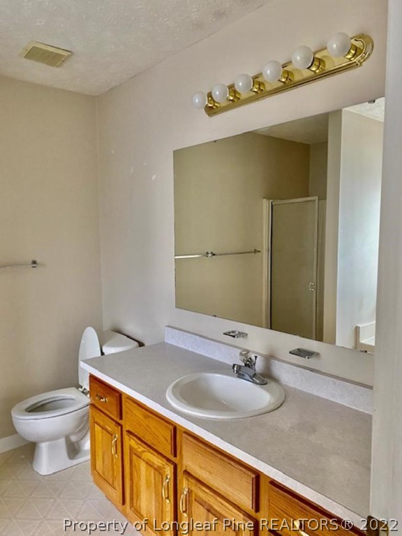 1945 Sardonyx Road, Unit 4 Fayetteville, NC 28303 - Photo 9 of 17 a bathroom with a granite countertop sink and a toilet
