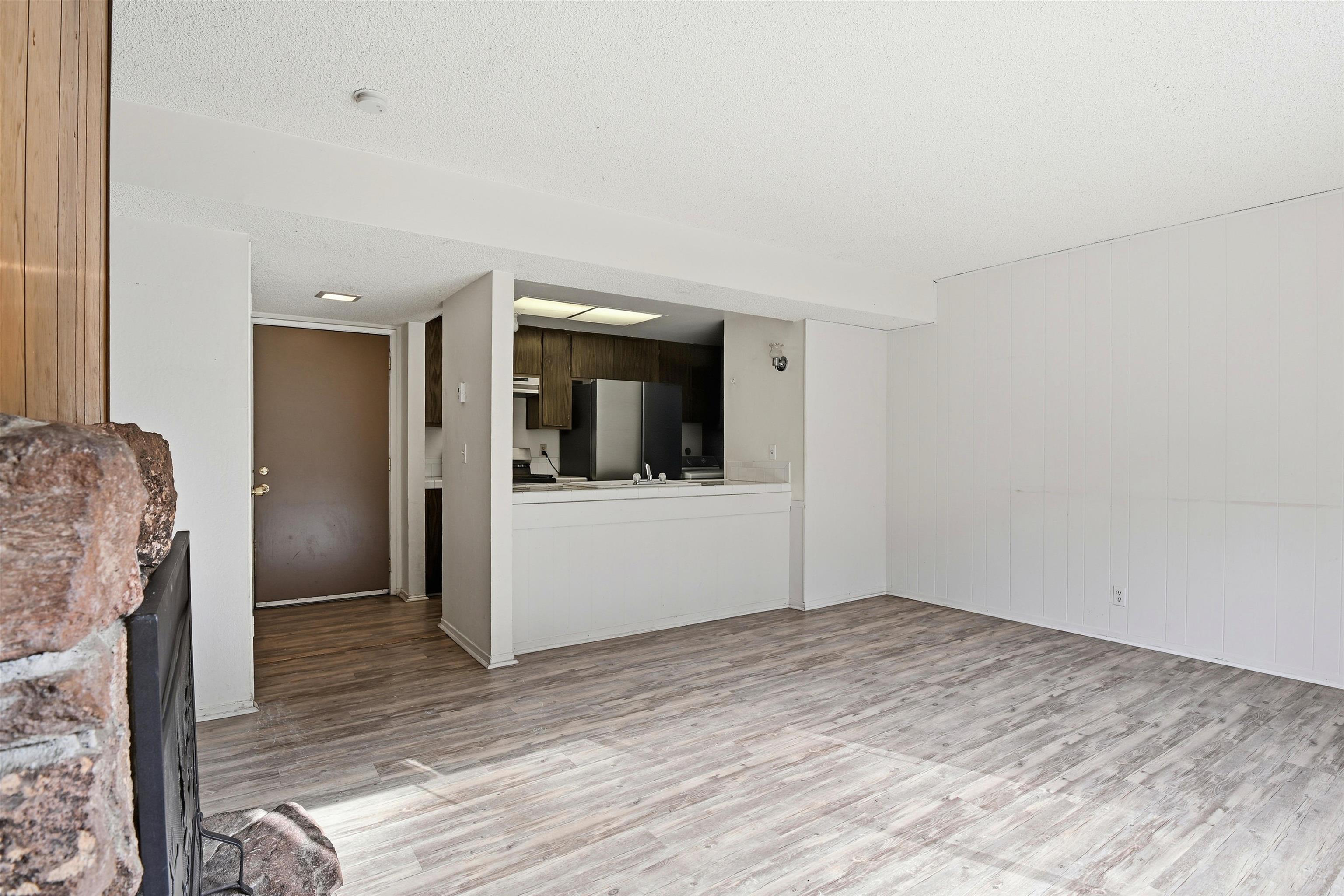 3101 Lake Forest Road, Unit 57 Tahoe City, CA 96145 - Photo 5 of 26 a view of a livingroom with wooden floor and kitchen