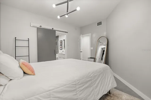 a bedroom with a bed and a mirror