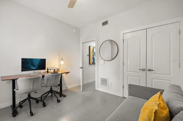 a view of a livingroom with workspace and a window