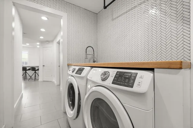 a view of washer and dryer with kitchen in the background