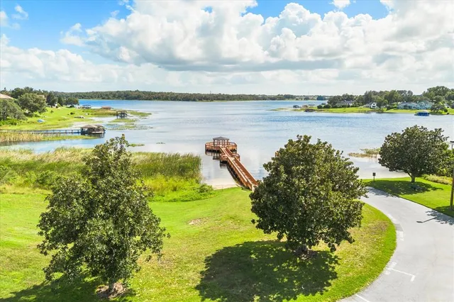 a view of a lake with houses in the back