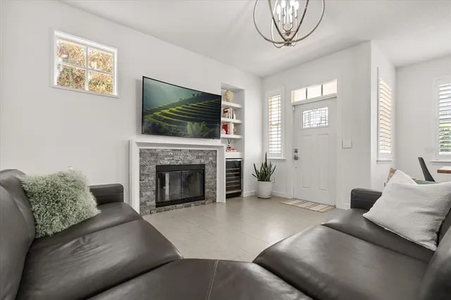 a living room with furniture a flat screen tv and a fireplace