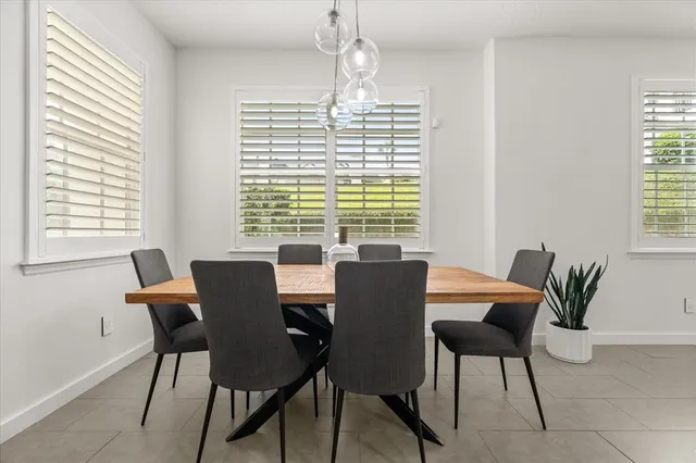 a view of a dining room with furniture and windows