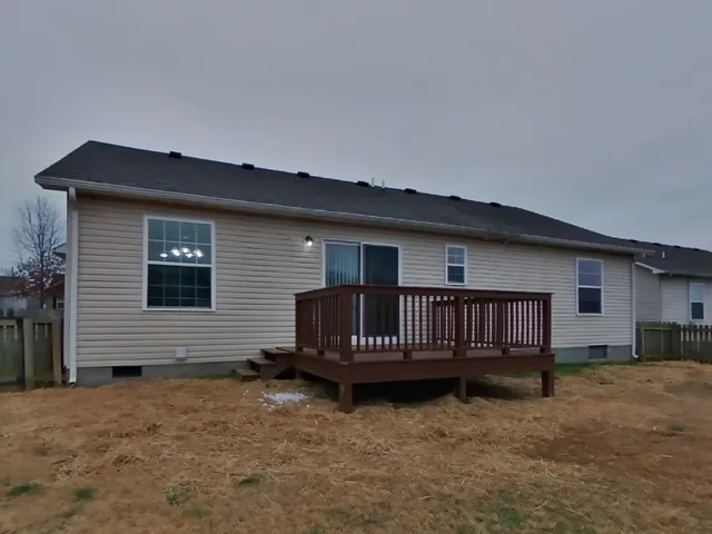 a view of backyard with a deck