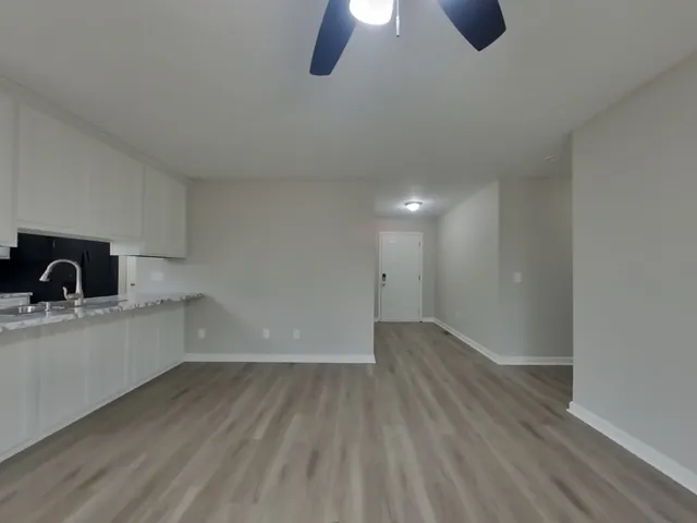 a view of workspace with wooden floor cabinet and window