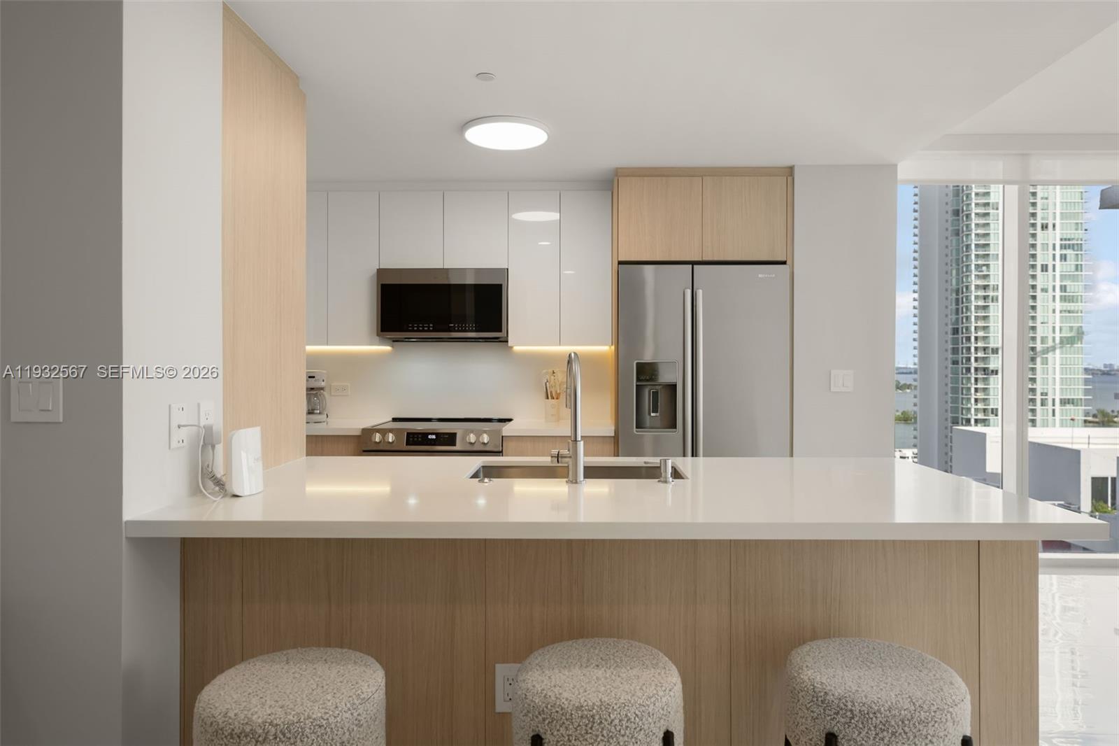 600 Northeast 27th Street, Unit 2401 Miami, FL 33137 - Photo 11 of 52 a kitchen with a sink a stove and a refrigerator