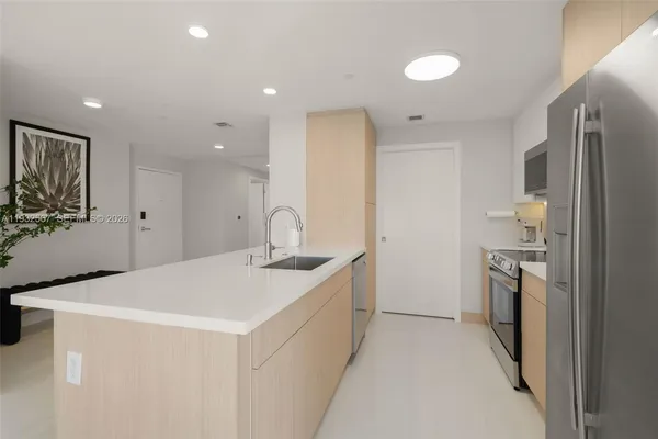 a kitchen with a sink and stainless steel appliances