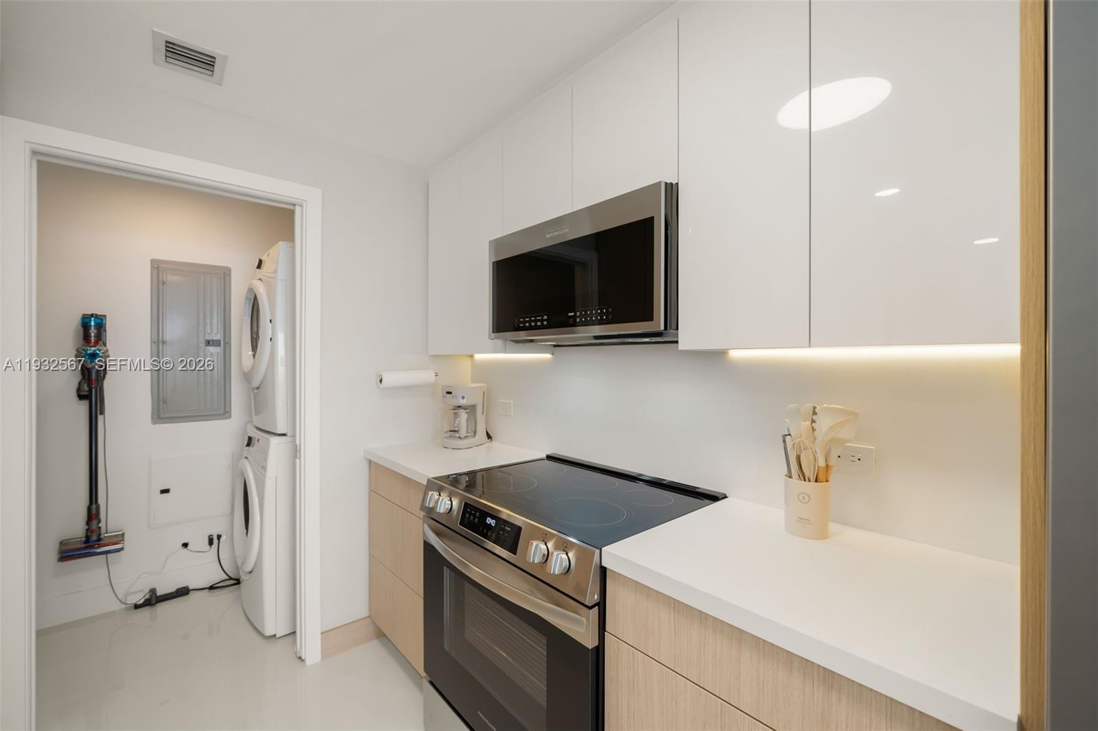 600 Northeast 27th Street, Unit 2401 Miami, FL 33137 - Photo 14 of 52 a kitchen with a stove and a microwave