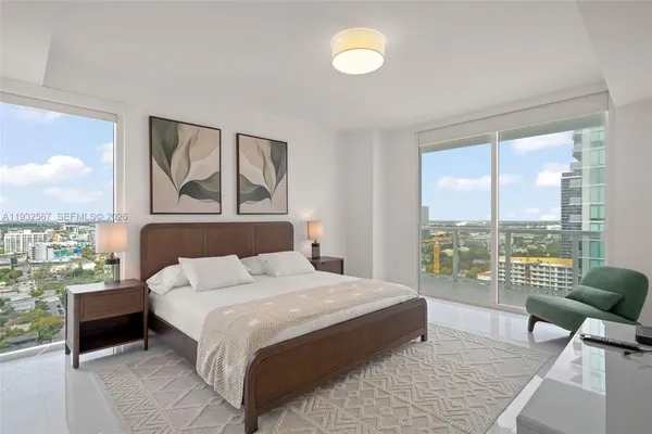 a bedroom with a large bed and a large window