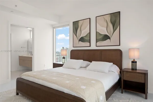 a bedroom with a bed and lamp