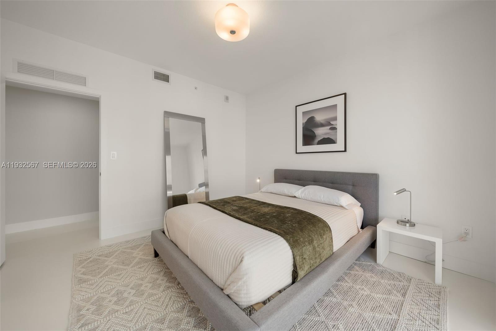 600 Northeast 27th Street, Unit 2401 Miami, FL 33137 - Photo 27 of 52 a bedroom with a bed and painting on the wall