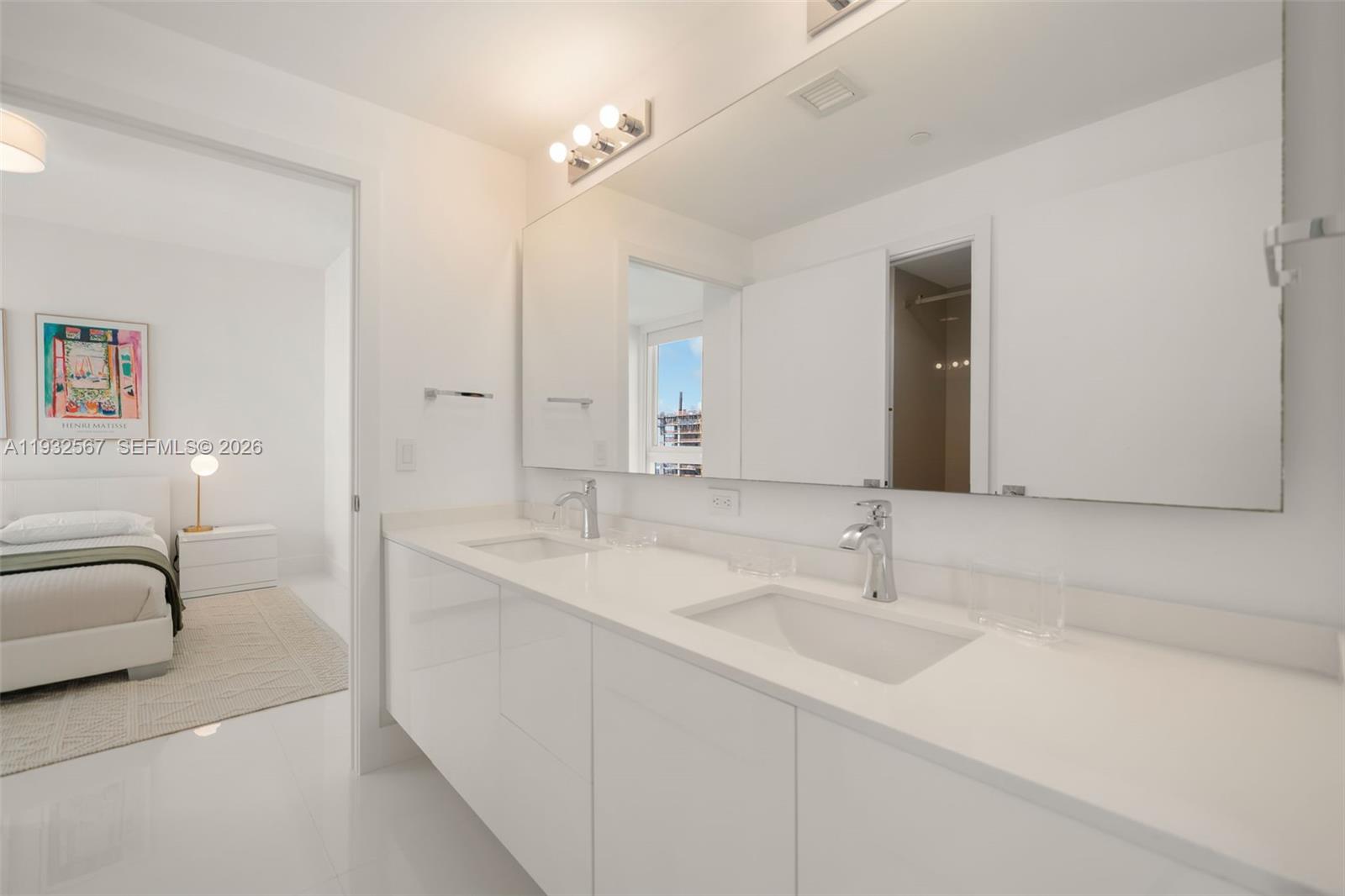 600 Northeast 27th Street, Unit 2401 Miami, FL 33137 - Photo 28 of 52 a en suite bathroom with a double vanity sink and a mirror