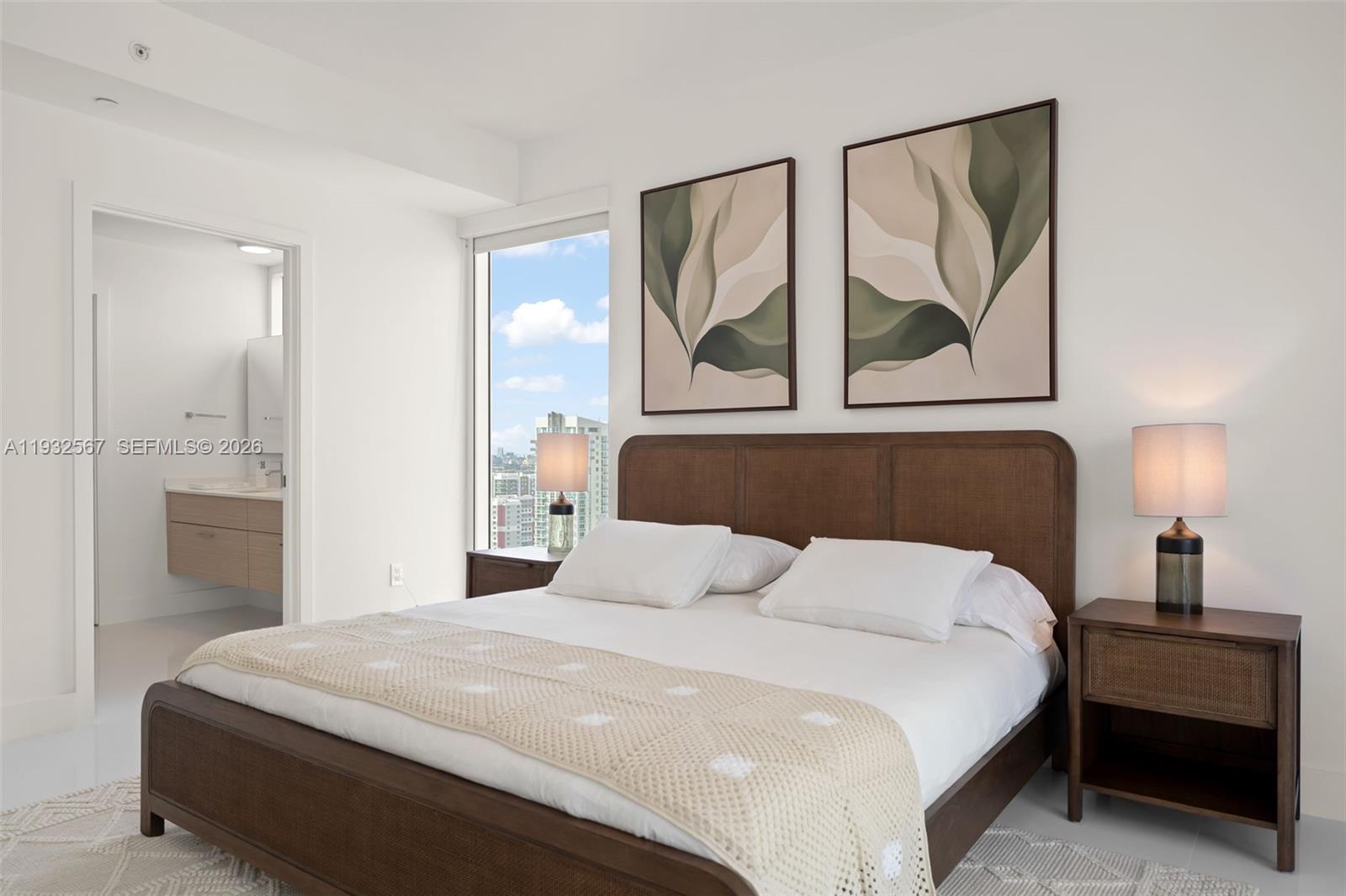 600 Northeast 27th Street, Unit 2401 Miami, FL 33137 - Photo 28 of 52 a bedroom with a bed and lamp