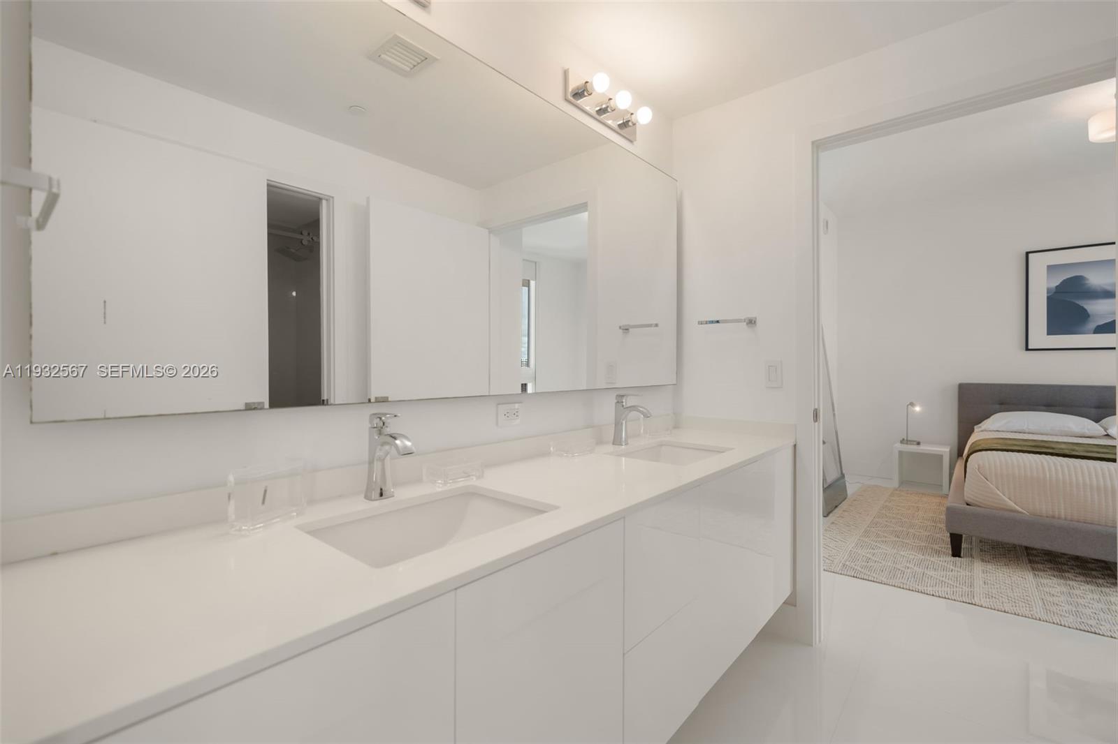 600 Northeast 27th Street, Unit 2401 Miami, FL 33137 - Photo 29 of 52 a en suite bathroom with a sink and a mirror