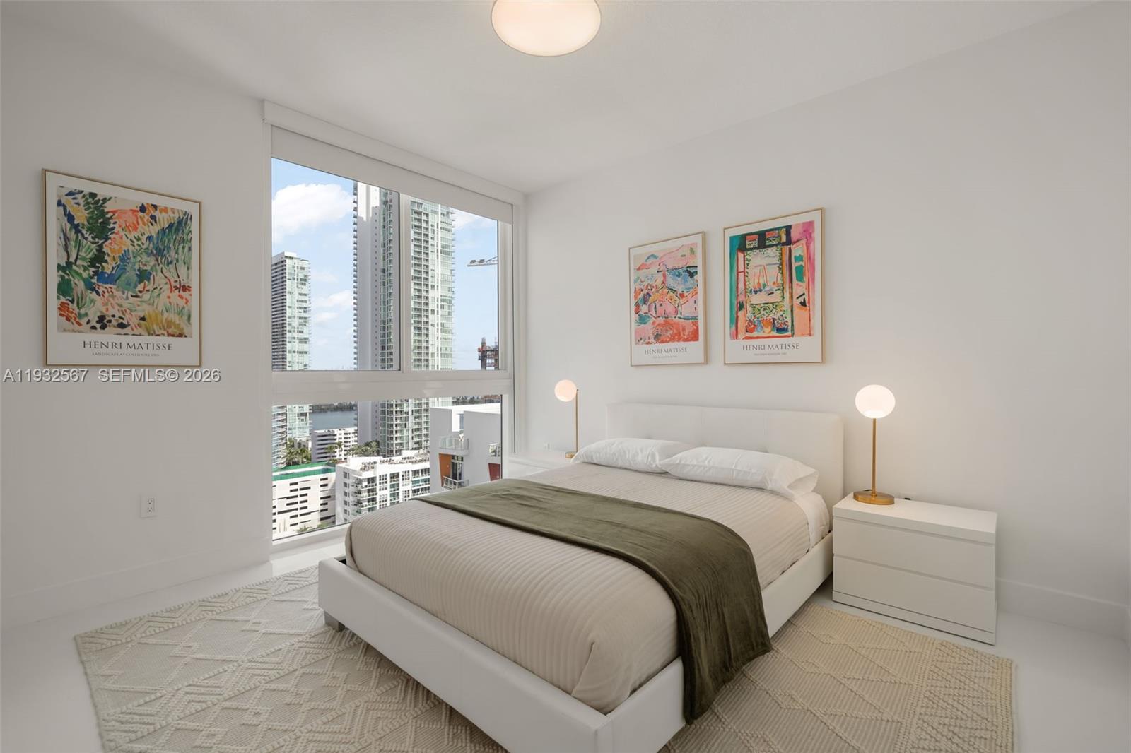 600 Northeast 27th Street, Unit 2401 Miami, FL 33137 - Photo 30 of 52 a bedroom with a bed and a painting on the wall
