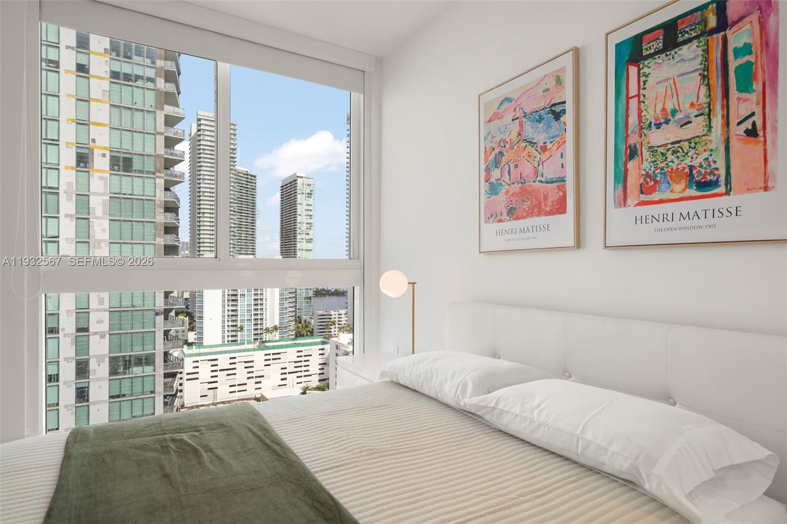 600 Northeast 27th Street, Unit 2401 Miami, FL 33137 - Photo 31 of 52 a bedroom with a bed and a painting on the wall