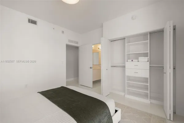 a bedroom with a bed and a walk in closet