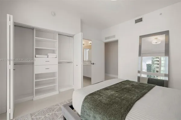 a bedroom with a bed and a cabinets