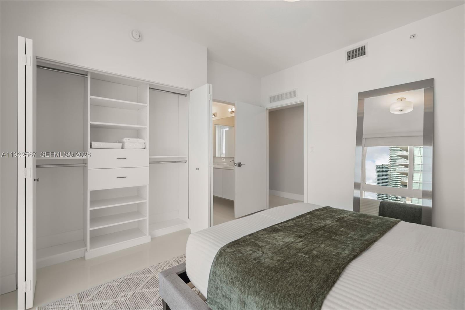 600 Northeast 27th Street, Unit 2401 Miami, FL 33137 - Photo 35 of 52 a bedroom with a bed and a cabinets