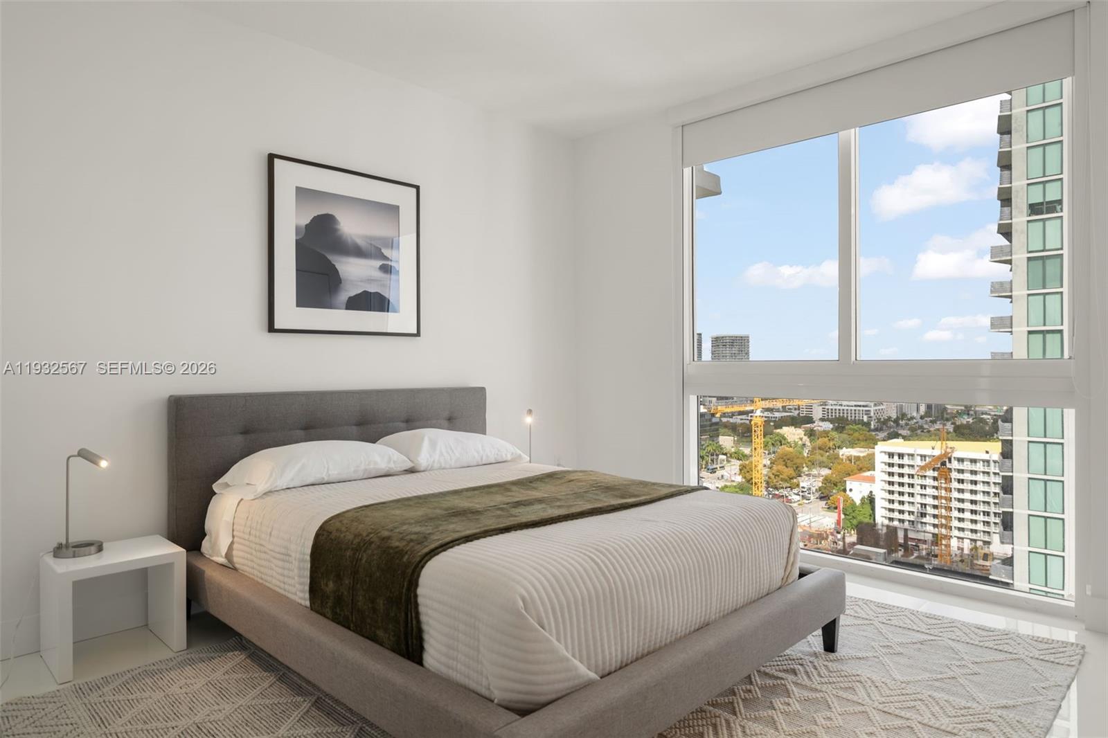 600 Northeast 27th Street, Unit 2401 Miami, FL 33137 - Photo 36 of 52 a bedroom with a bed and a large window