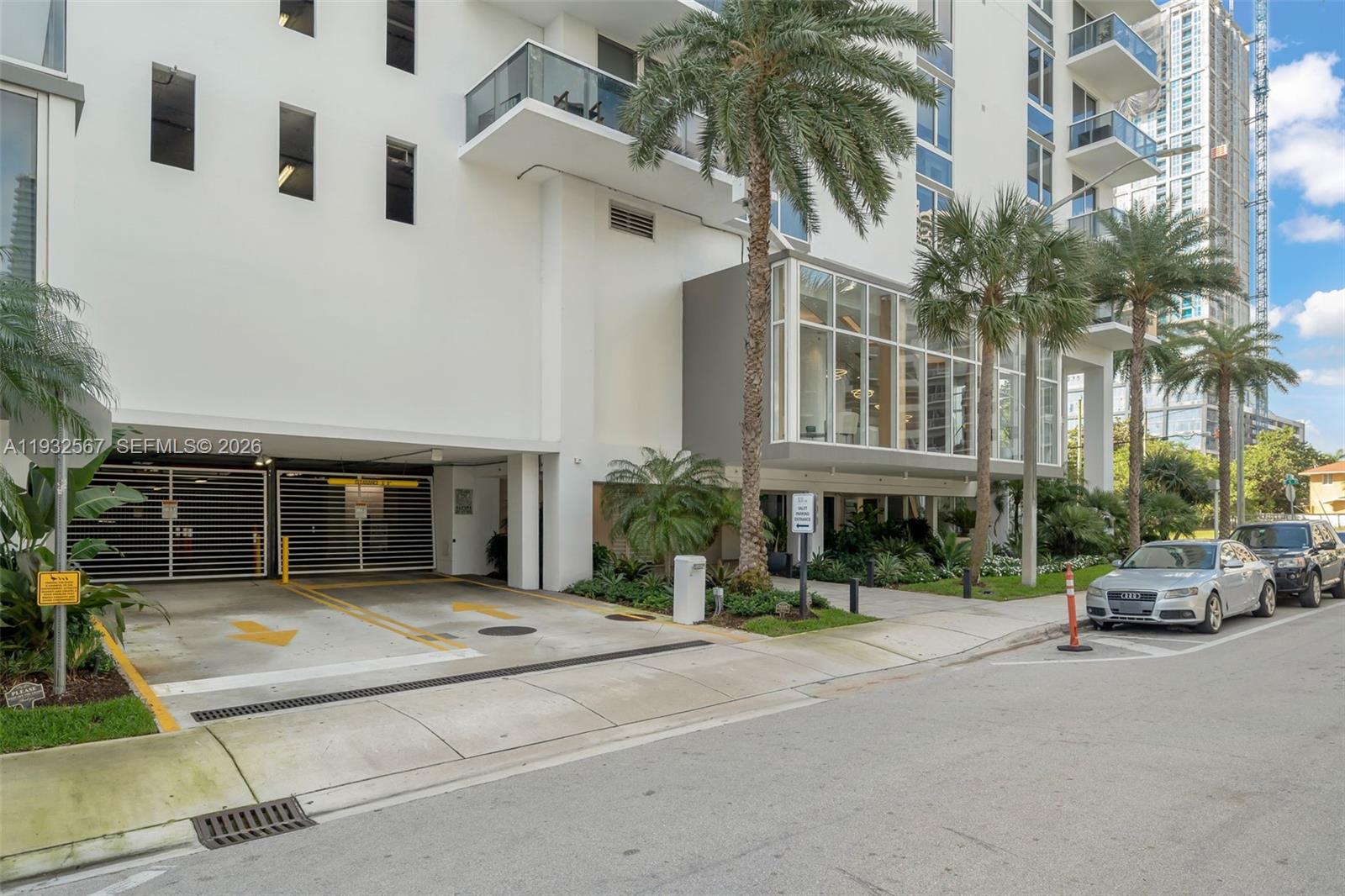 600 Northeast 27th Street, Unit 2401 Miami, FL 33137 - Photo 37 of 52 a car parked in front of building with palm trees