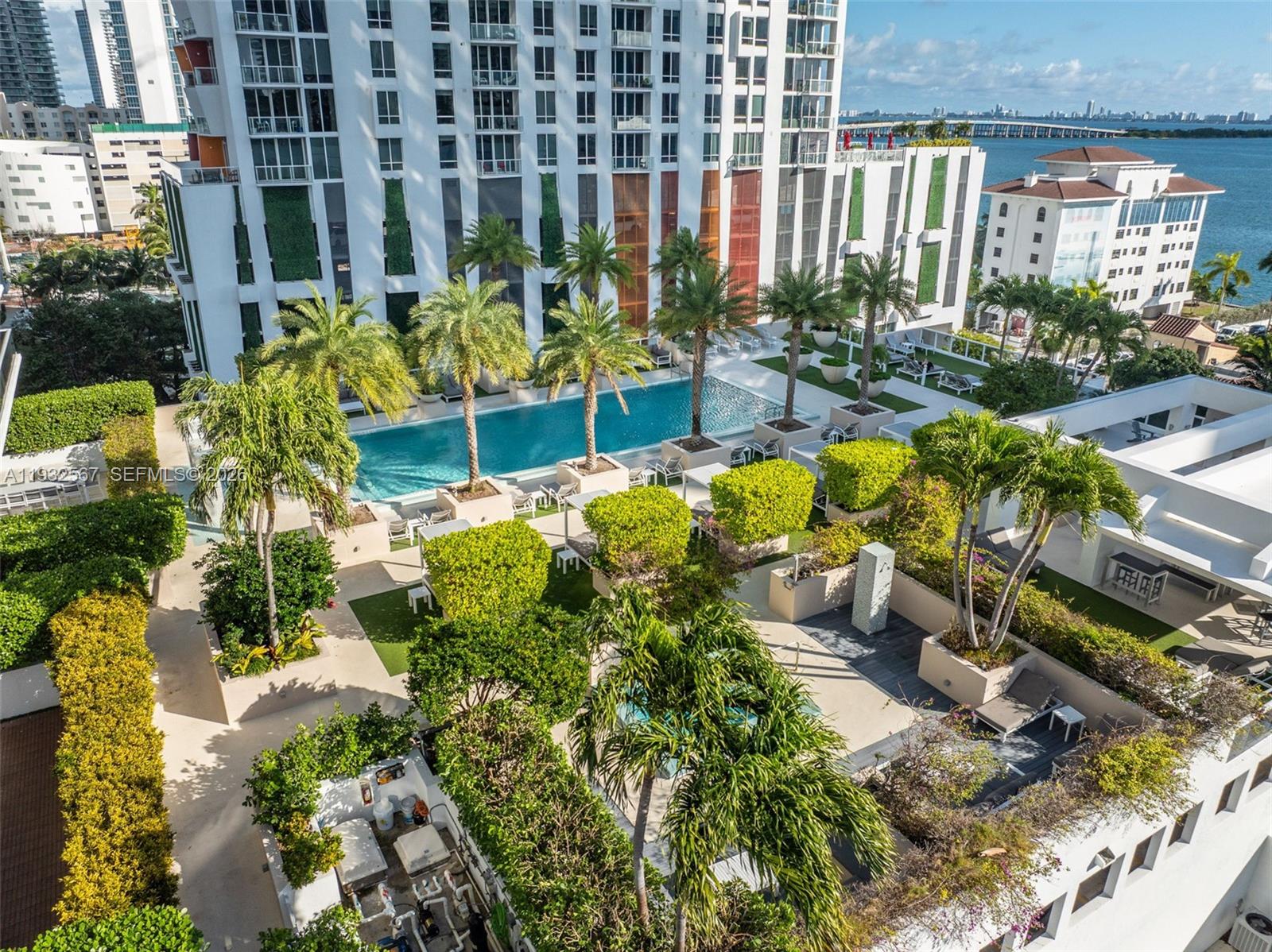 600 Northeast 27th Street, Unit 2401 Miami, FL 33137 - Photo 48 of 52 a view of a swimming pool with lawn chairs and potted plants