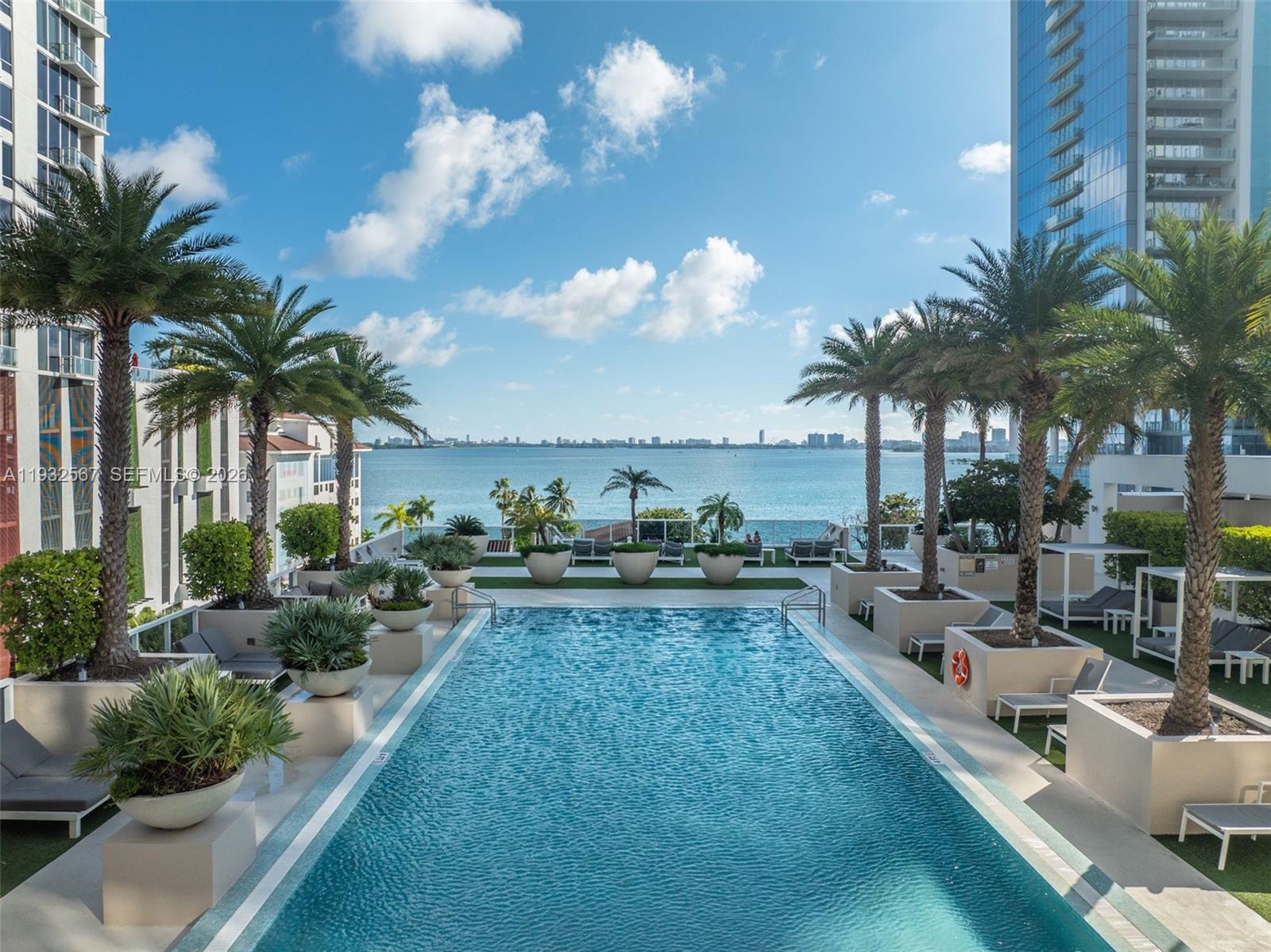 600 Northeast 27th Street, Unit 2401 Miami, FL 33137 - Photo 51 of 52 a view of a swimming pool and lounge chair