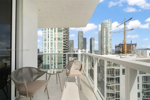 a view of a city from a living room filled with furniture