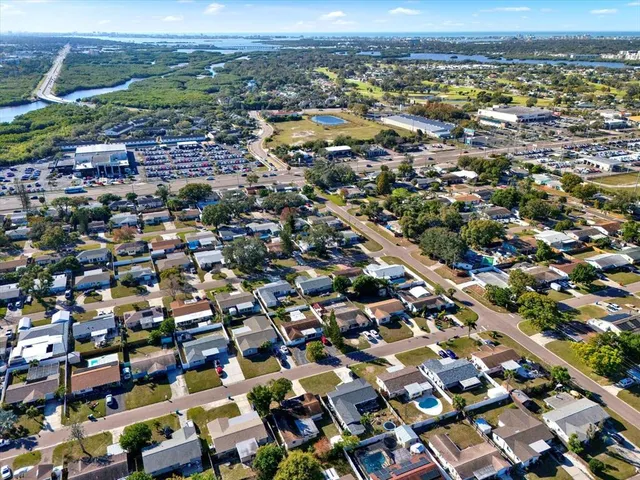 an aerial view of residential houses with city view