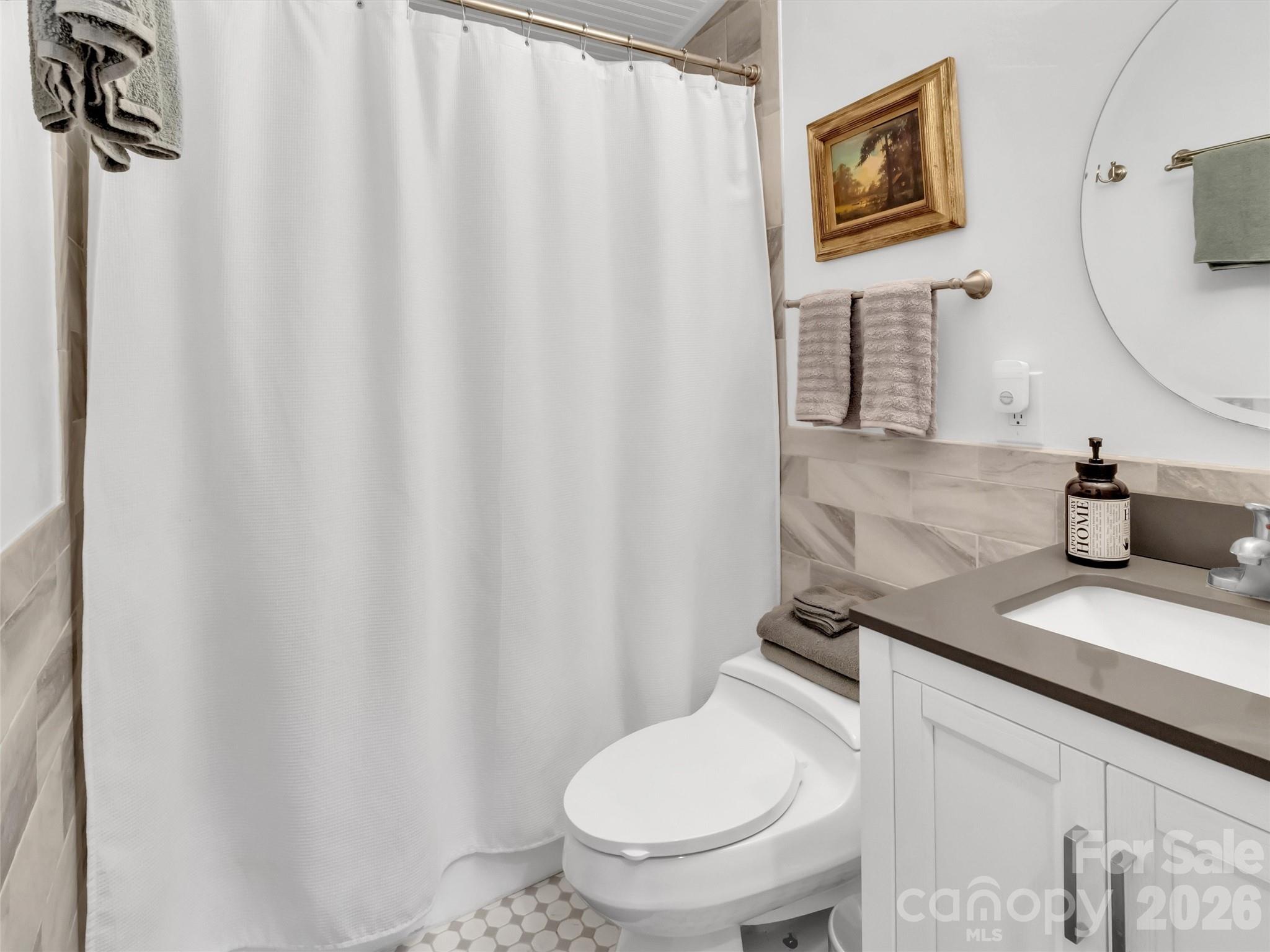 70 Icicle Ridge Road Sylva, NC 28779 - Photo 24 of 24 a white toilet sitting next to a bathroom sink
