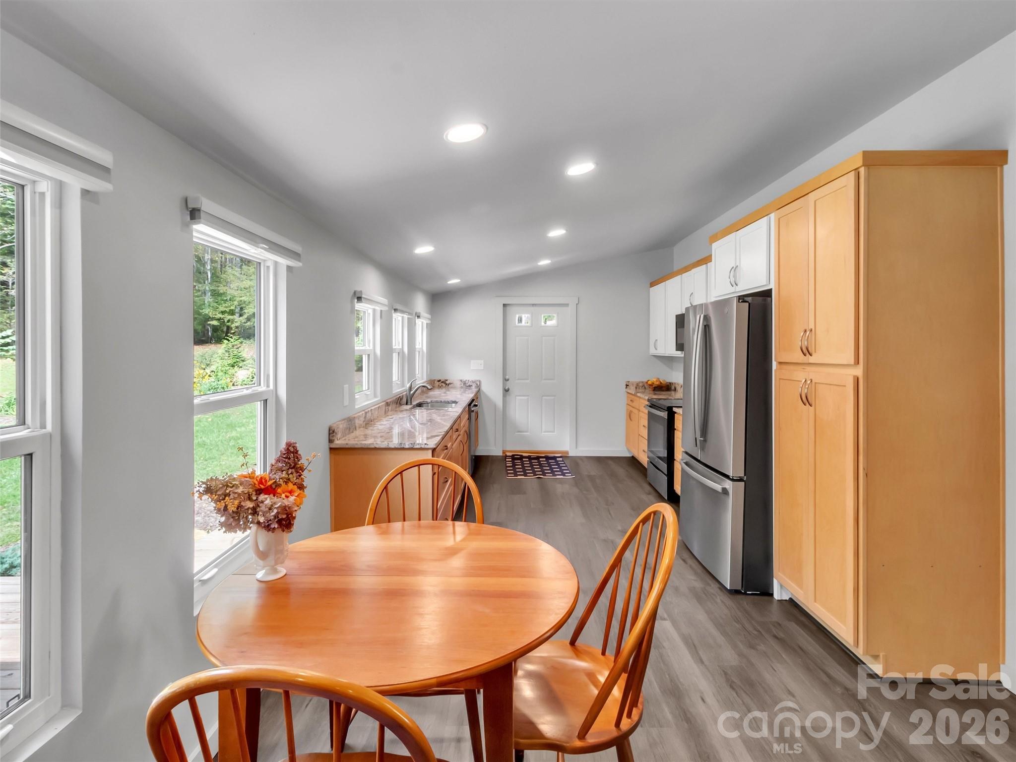 70 Icicle Ridge Road Sylva, NC 28779 - Photo 8 of 24 a dining room with furniture a window and stainless steel appliances
