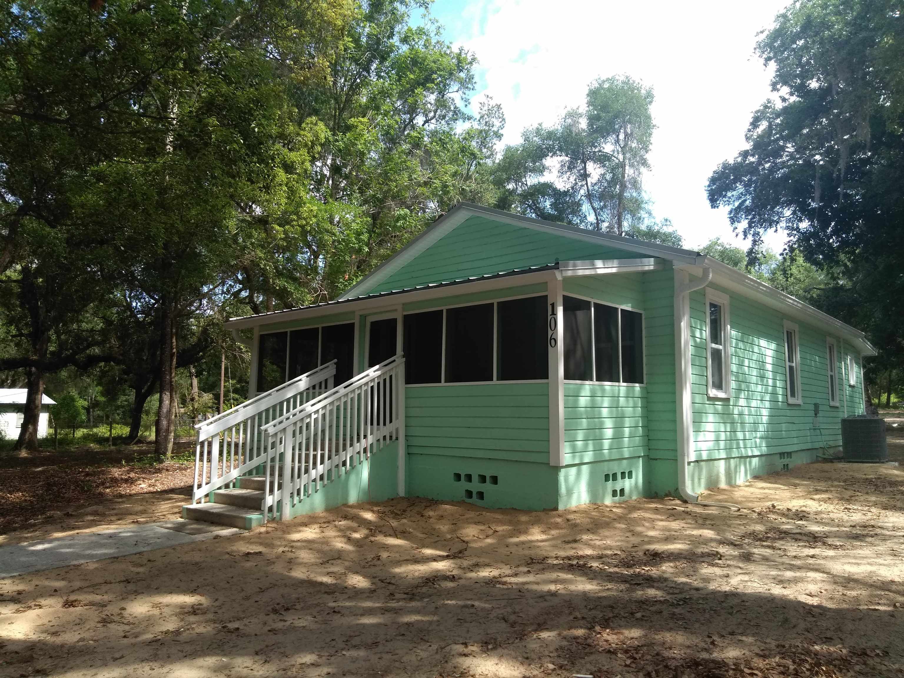 106 Putnam Loop Road Melrose, FL 32666 - Photo 1 of 28 a front view of a house with a garden