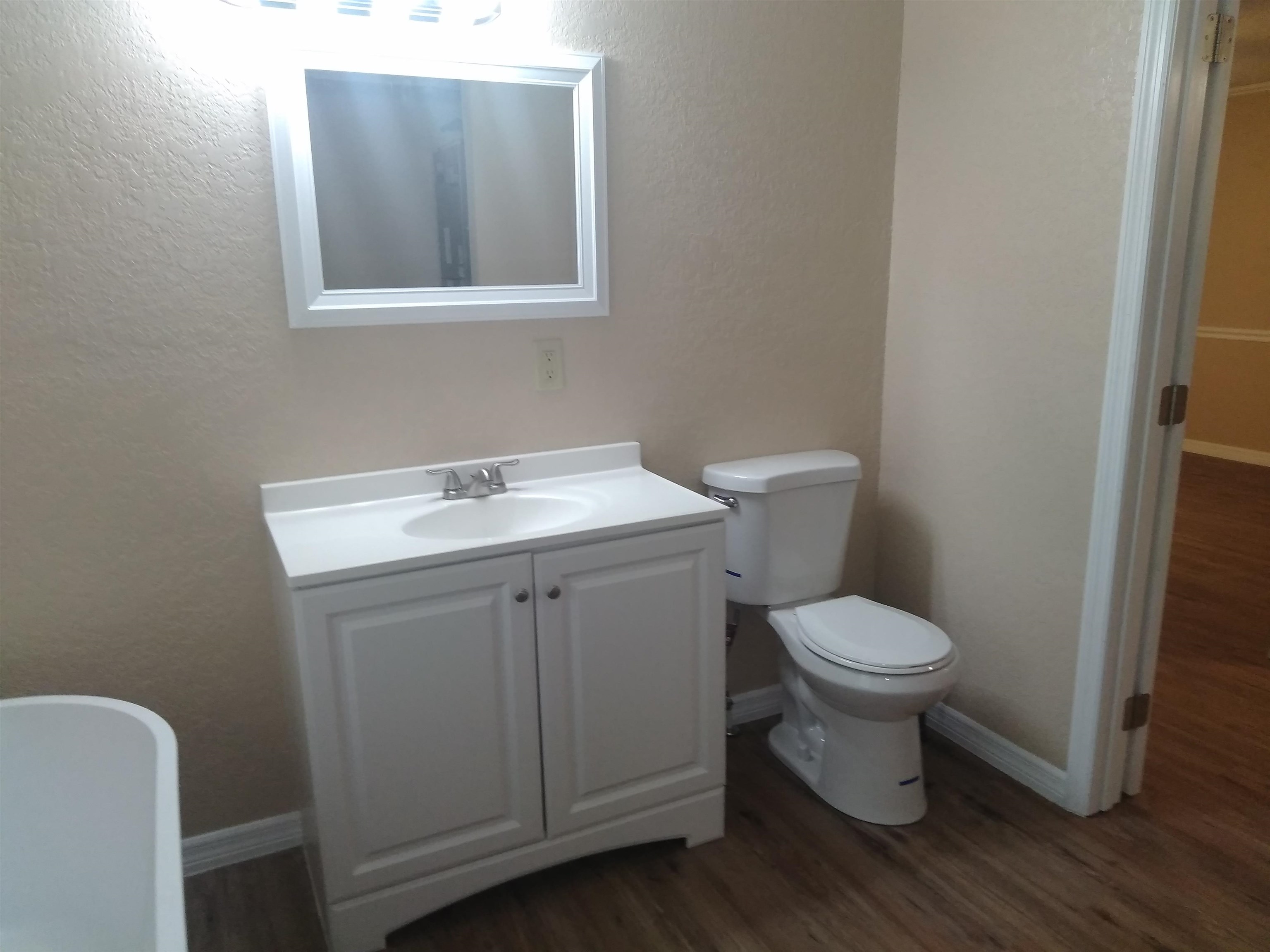 106 Putnam Loop Road Melrose, FL 32666 - Photo 14 of 28 a white toilet sitting next to a bathroom sink