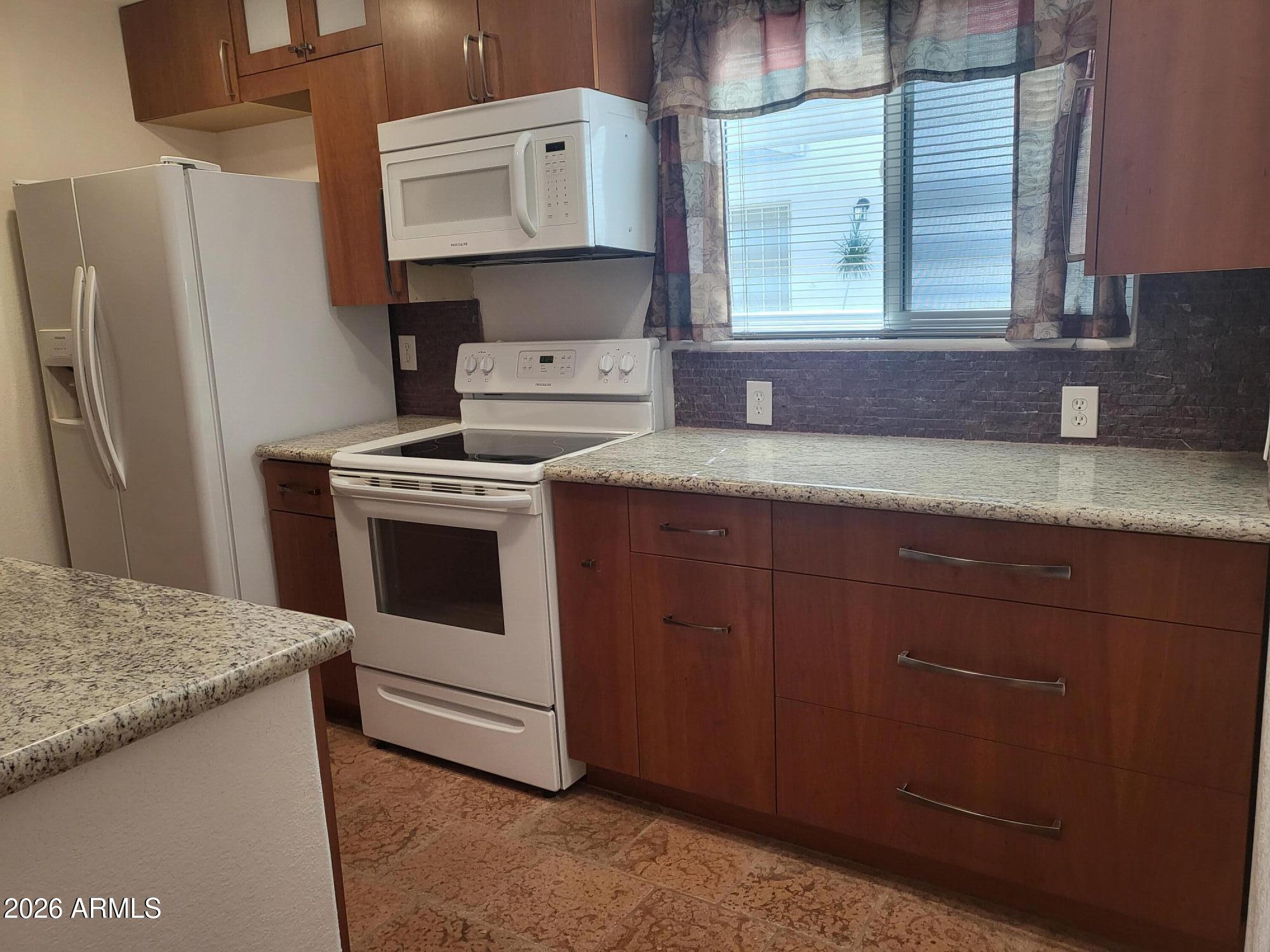 825 North Hayden Road, Unit C108 Scottsdale, AZ 85257 - Photo 13 of 34 a kitchen with a stove and a refrigerator