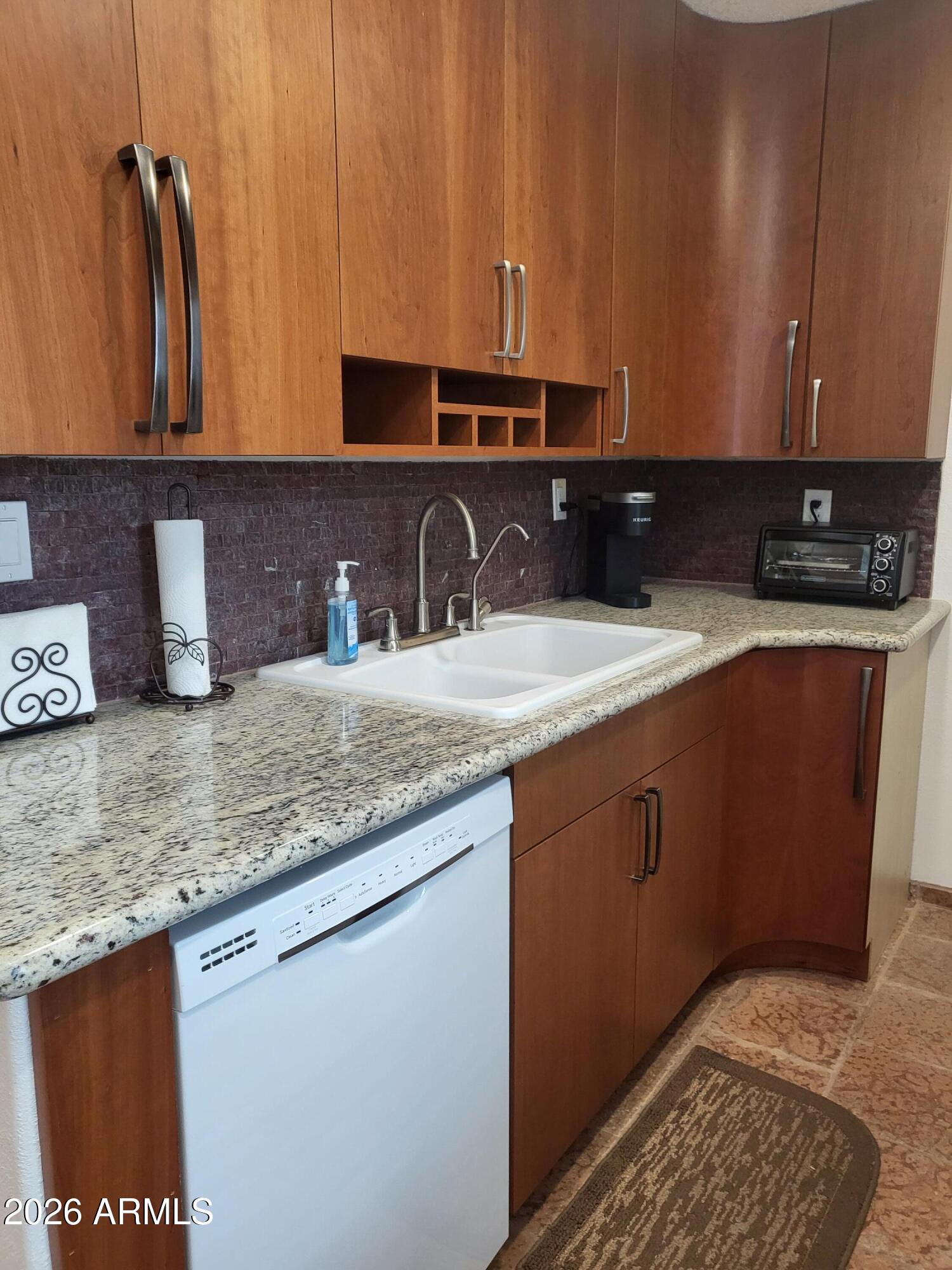 825 North Hayden Road, Unit C108 Scottsdale, AZ 85257 - Photo 15 of 34 a kitchen with granite countertop a sink and a stove