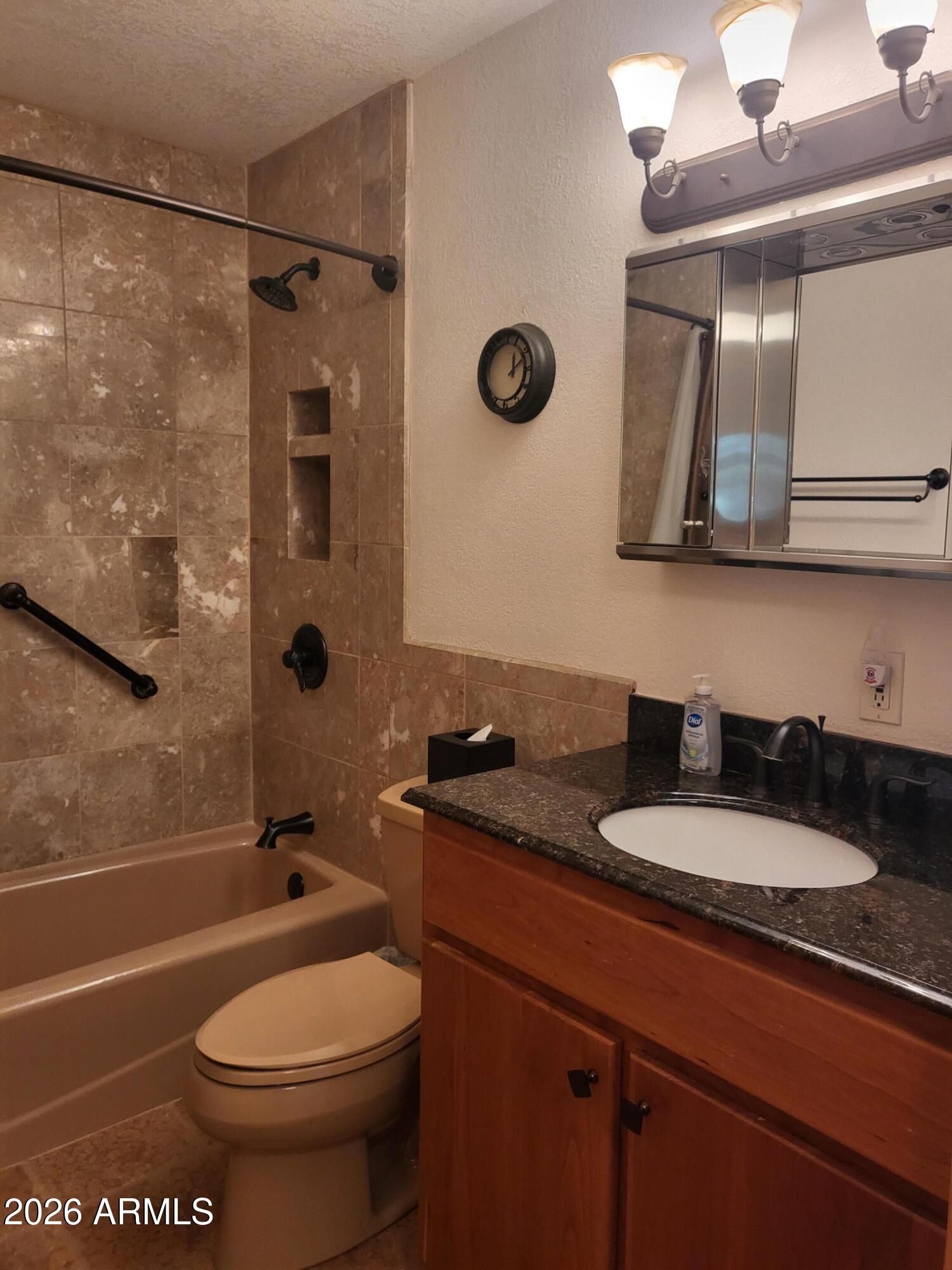 825 North Hayden Road, Unit C108 Scottsdale, AZ 85257 - Photo 18 of 34 a bathroom with a granite countertop toilet sink and mirror