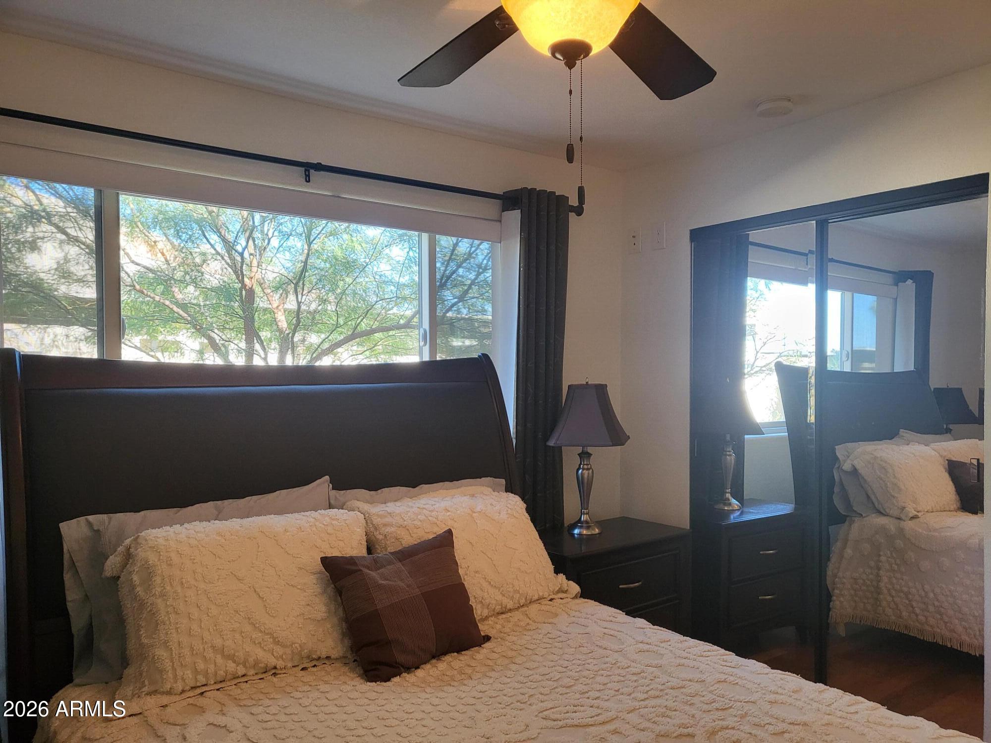 825 North Hayden Road, Unit C108 Scottsdale, AZ 85257 - Photo 19 of 34 a bedroom with a bed and a chandelier