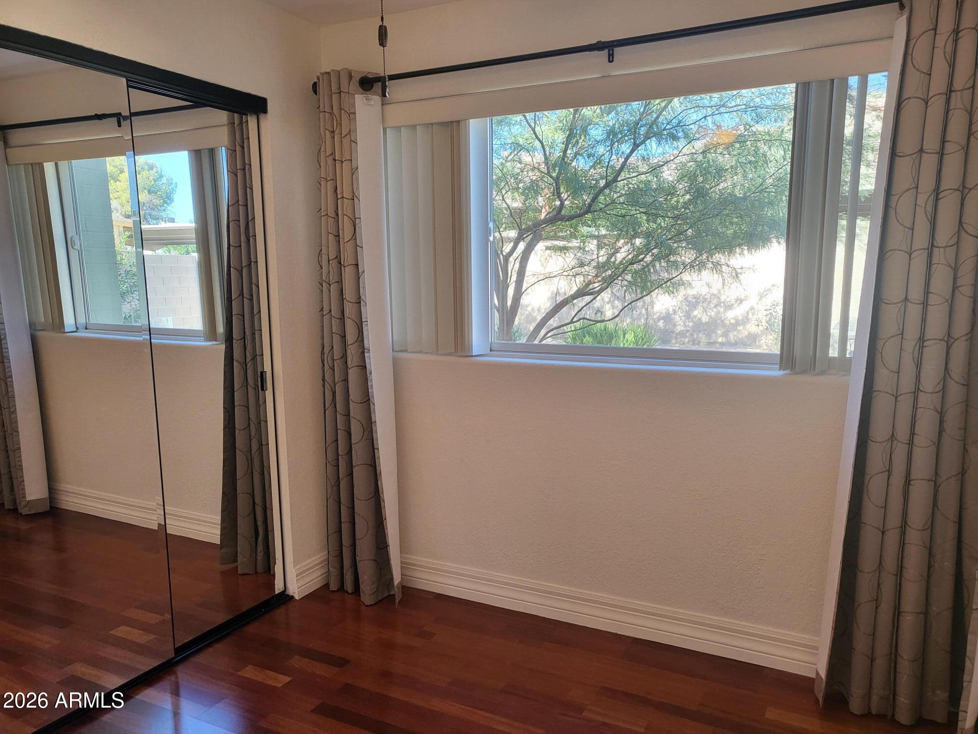 825 North Hayden Road, Unit C108 Scottsdale, AZ 85257 - Photo 21 of 34 a view of empty room with wooden floor and fan