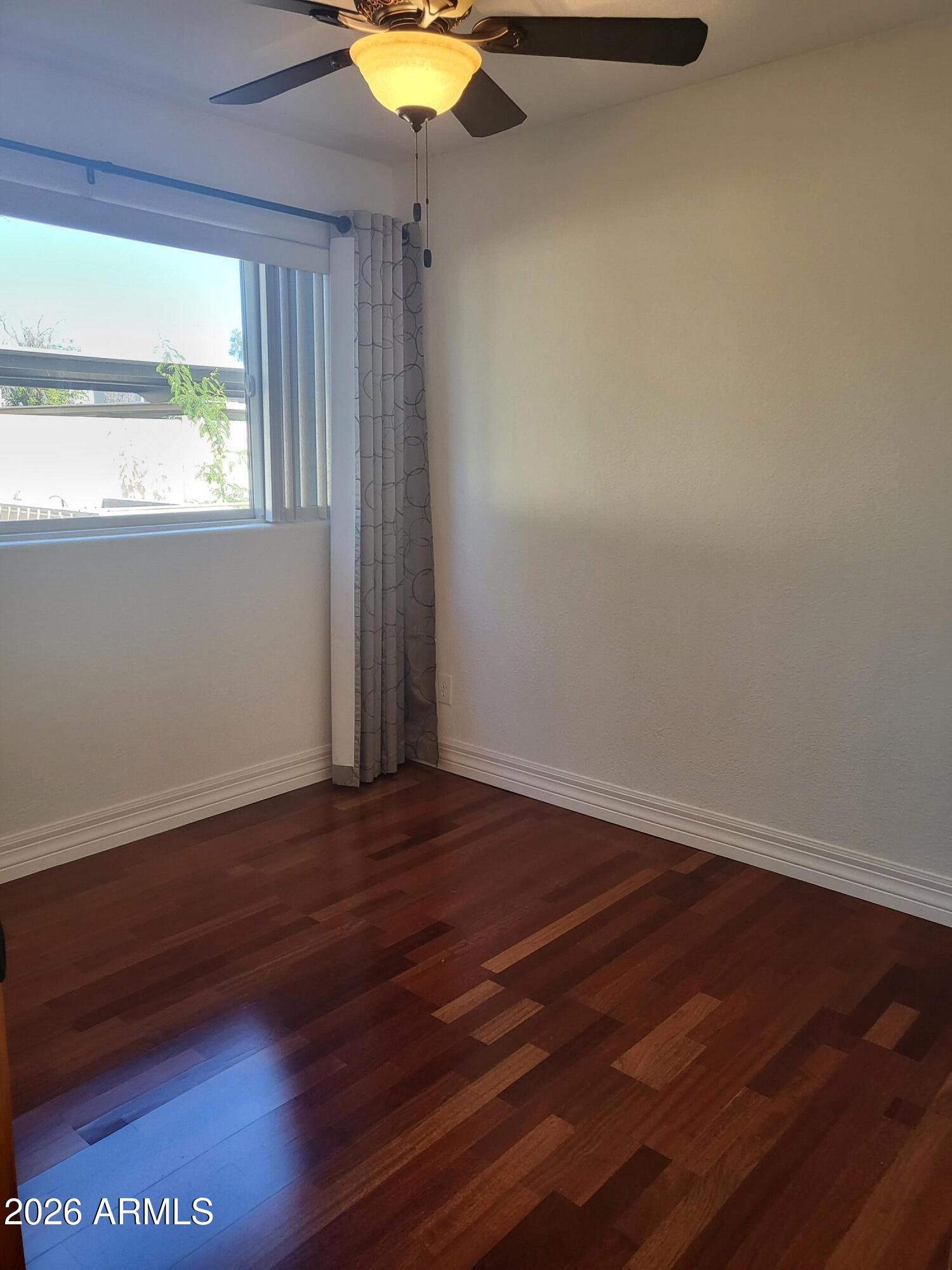825 North Hayden Road, Unit C108 Scottsdale, AZ 85257 - Photo 22 of 34 a view of an empty room with wooden floor and a window