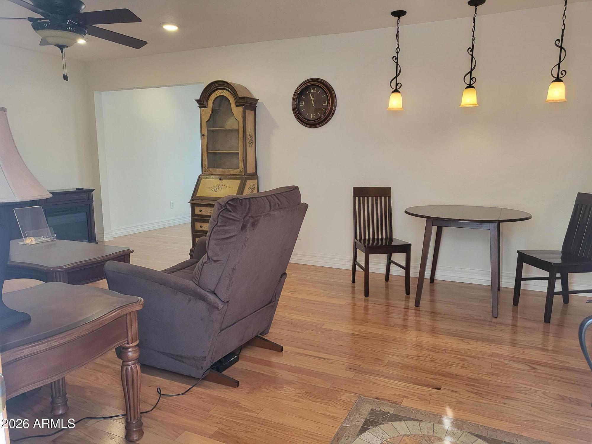 825 North Hayden Road, Unit C108 Scottsdale, AZ 85257 - Photo 3 of 34 a living room with furniture and a wooden floor