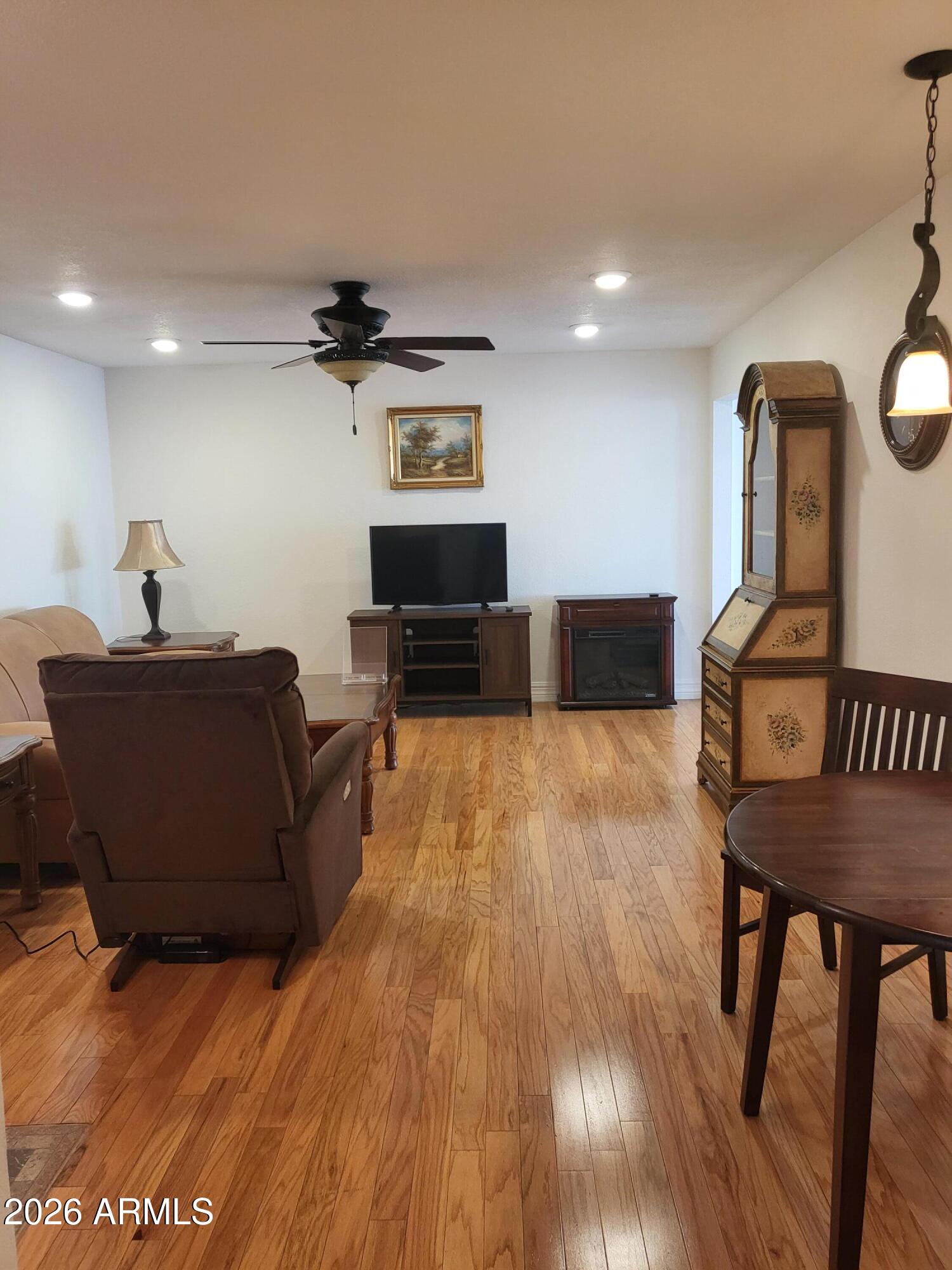 825 North Hayden Road, Unit C108 Scottsdale, AZ 85257 - Photo 6 of 34 a living room with furniture and a wooden floor