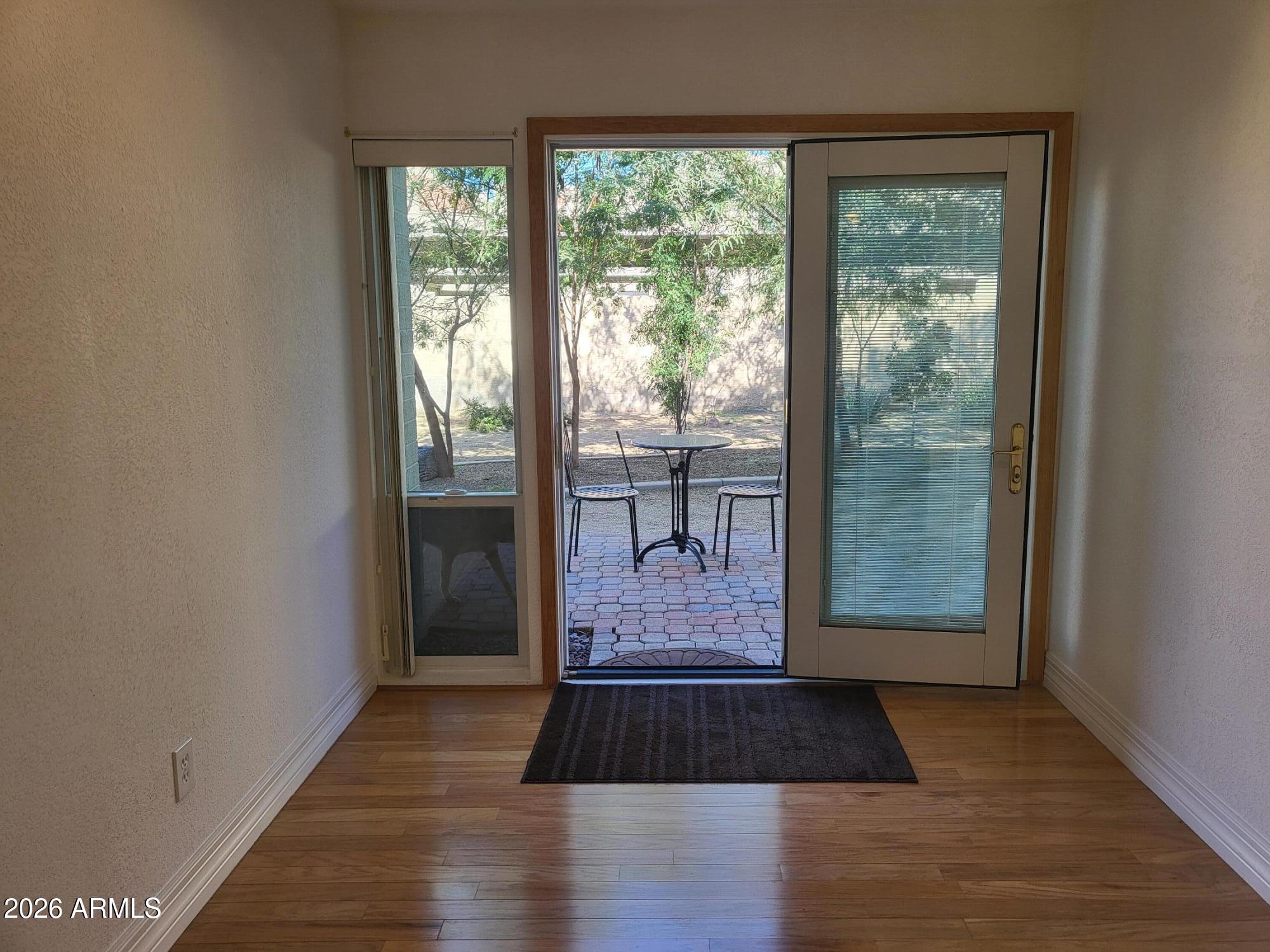 825 North Hayden Road, Unit C108 Scottsdale, AZ 85257 - Photo 9 of 34 a view of a room with wooden floor and glass door