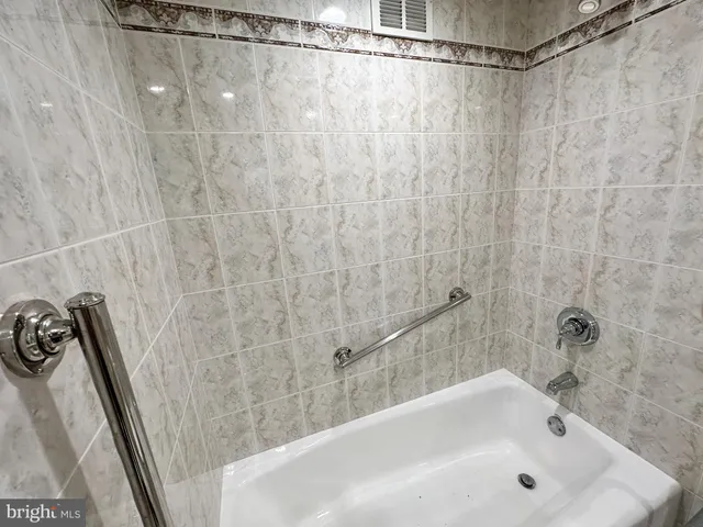 a bathroom with a shower and a bath tub