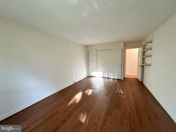 a view of walk in closet with empty racks